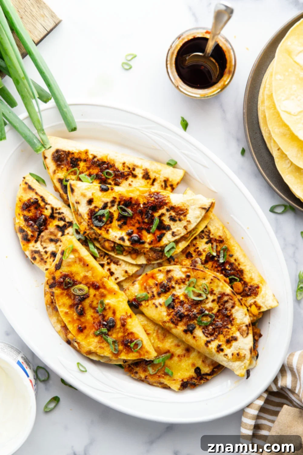 Golden Smashed Chickpea Tacos 5 These crispy chickpea tacos feature a smashed chickpea filling with two kinds of gooey cheese melted inside and lots of spicy chili crisp.