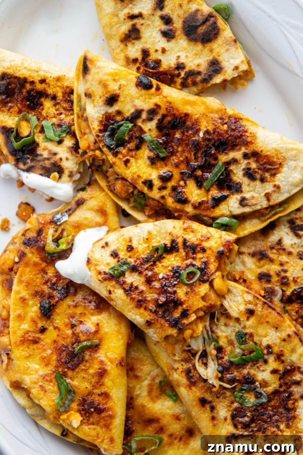 Golden Smashed Chickpea Tacos 6 These crispy chickpea tacos feature a smashed chickpea filling with two kinds of gooey cheese melted inside and lots of spicy chili crisp.