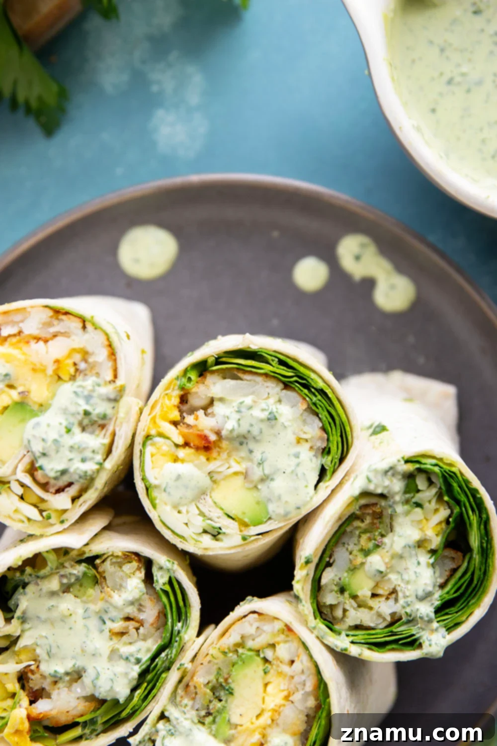 Vibrant Green Goddess Breakfast Burritos 4 Assembled Green Goddess Breakfast Burritos ready for serving, showcasing the vibrant ingredients.