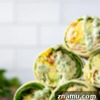 These green goddess breakfast burritos feature soft flour tortillas stuffed with fluffy scrambled eggs, crispy hashbrowns, lots of greens, and a flavorful homemade green goddess sauce.