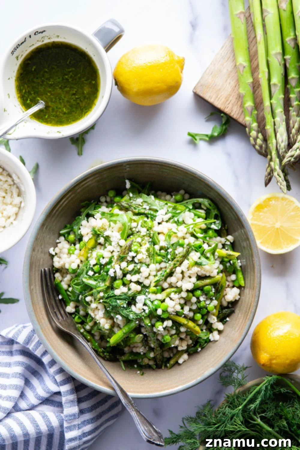 Spring Asparagus Couscous Salad with Zesty Dill Vinaigrette 6 A serving of Asparagus Couscous Salad with fresh dill vinaigrette, ready to be enjoyed as a light and healthy meal.