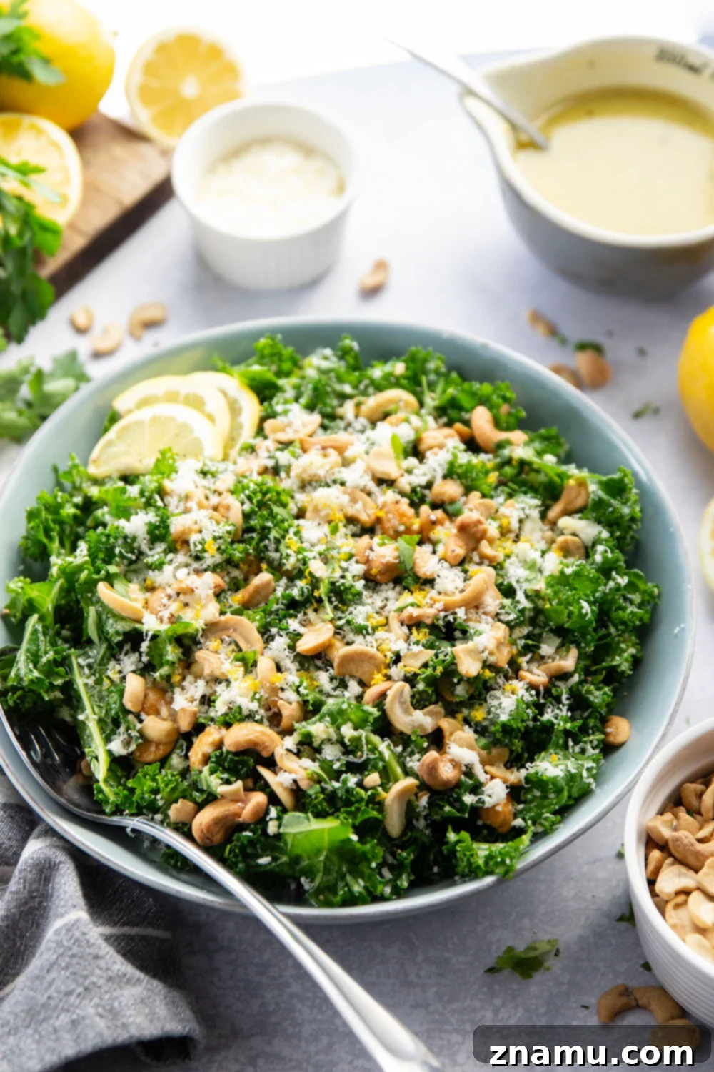 Lemon Kissed Asiago Cashew Kale 4 A bowl of fresh kale, ready to be massaged and combined with the dressing and other ingredients for the salad.