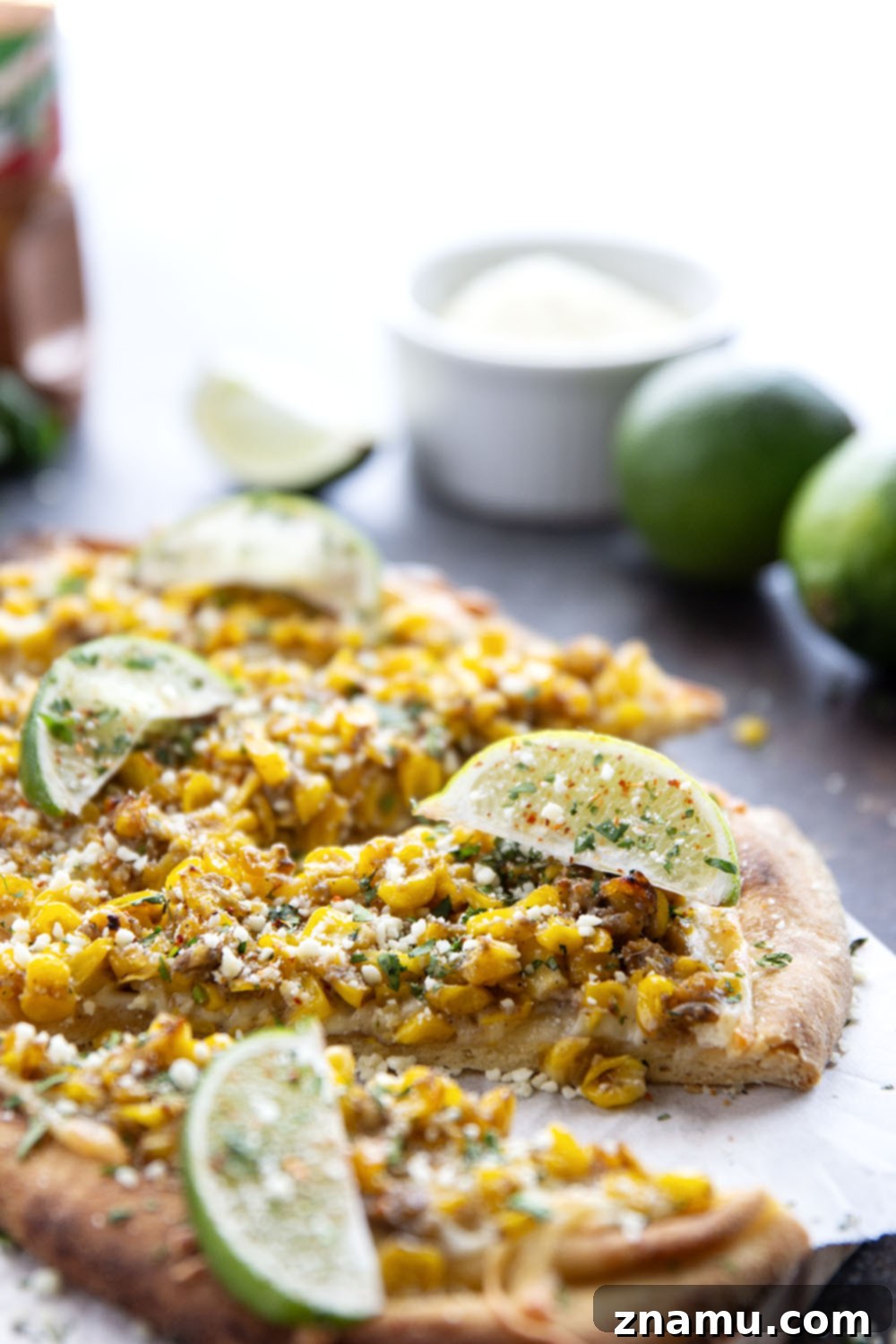 Elote Flatbread 6 Plated Mexican Street Corn Flatbread garnished with cotija, cilantro, and lime