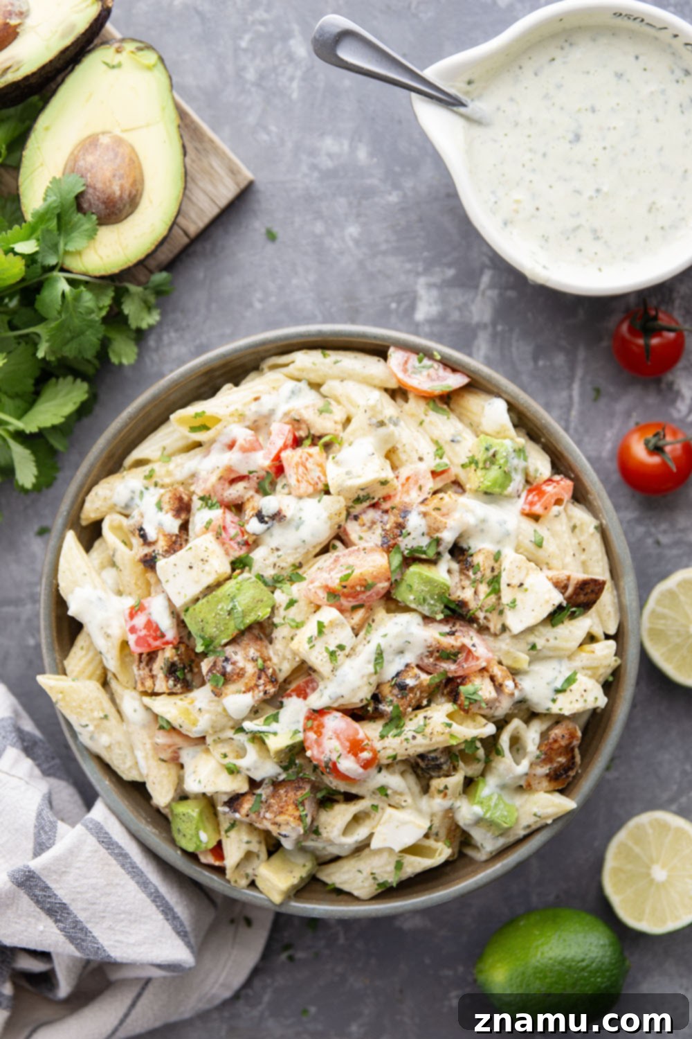 An overhead shot of a large bowl of Blackened Chicken Avocado Pasta Salad, garnished with fresh cilantro.
