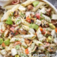 Spicy blackened chicken, silky avocado, and a creamy roasted tomatillo dressing pack so much flavor into this chicken avocado pasta salad.