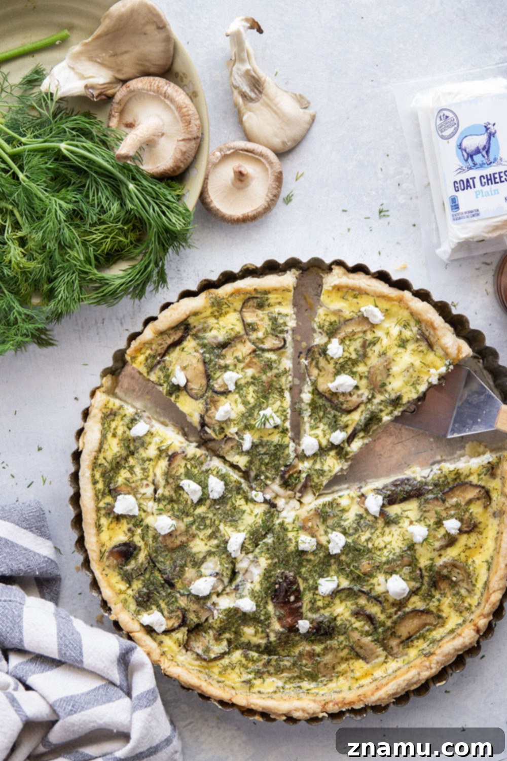 Rustic Wild Mushroom Goat Cheese Quiche 6 A serving of Wild Mushroom Goat Cheese Quiche, plated and ready to be enjoyed.