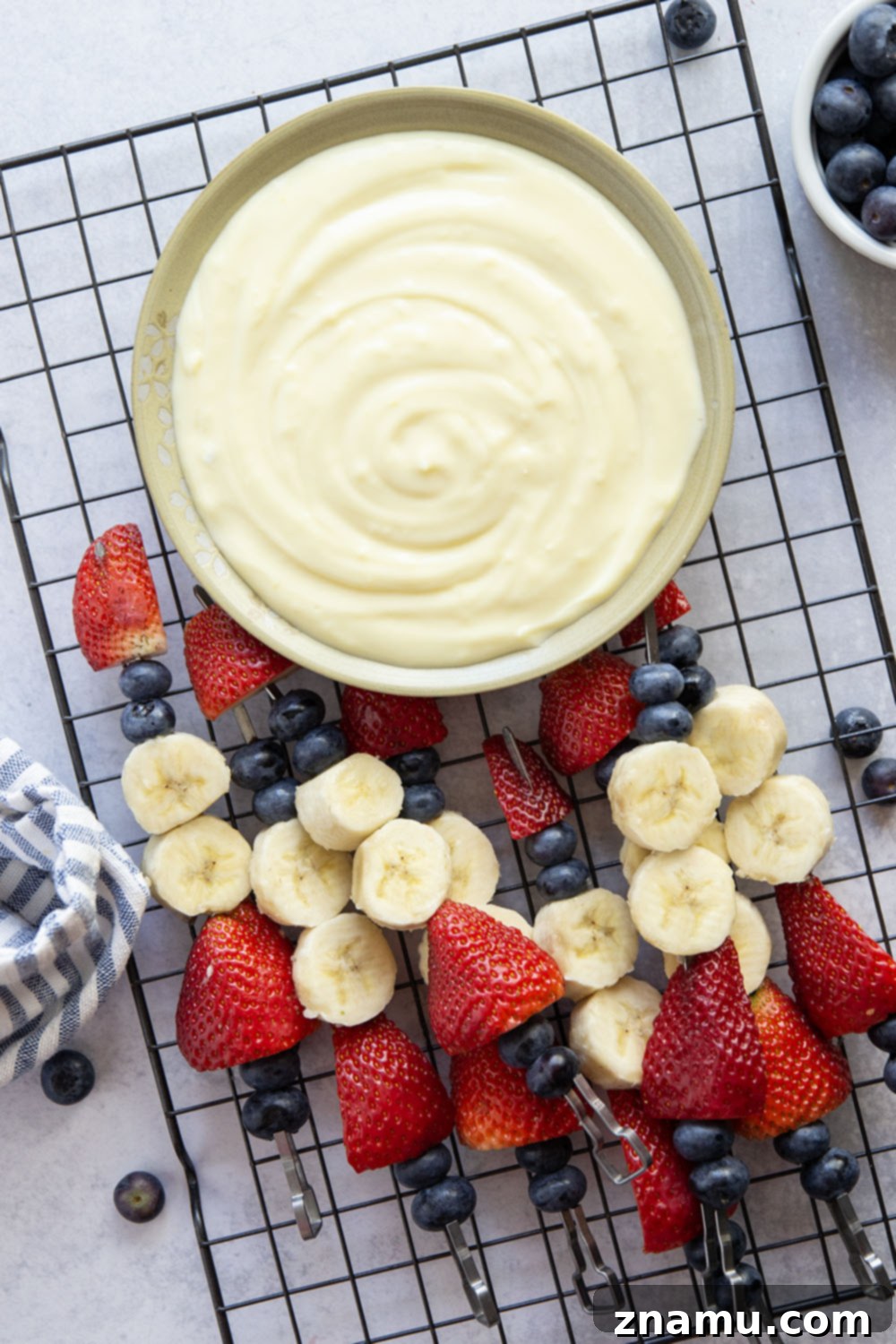 Patriotic Fruit Skewers with Creamy Vanilla Dip 3 Close-up shot of juicy Red White and Blue Fruit Kabobs with a side of homemade vanilla dip.