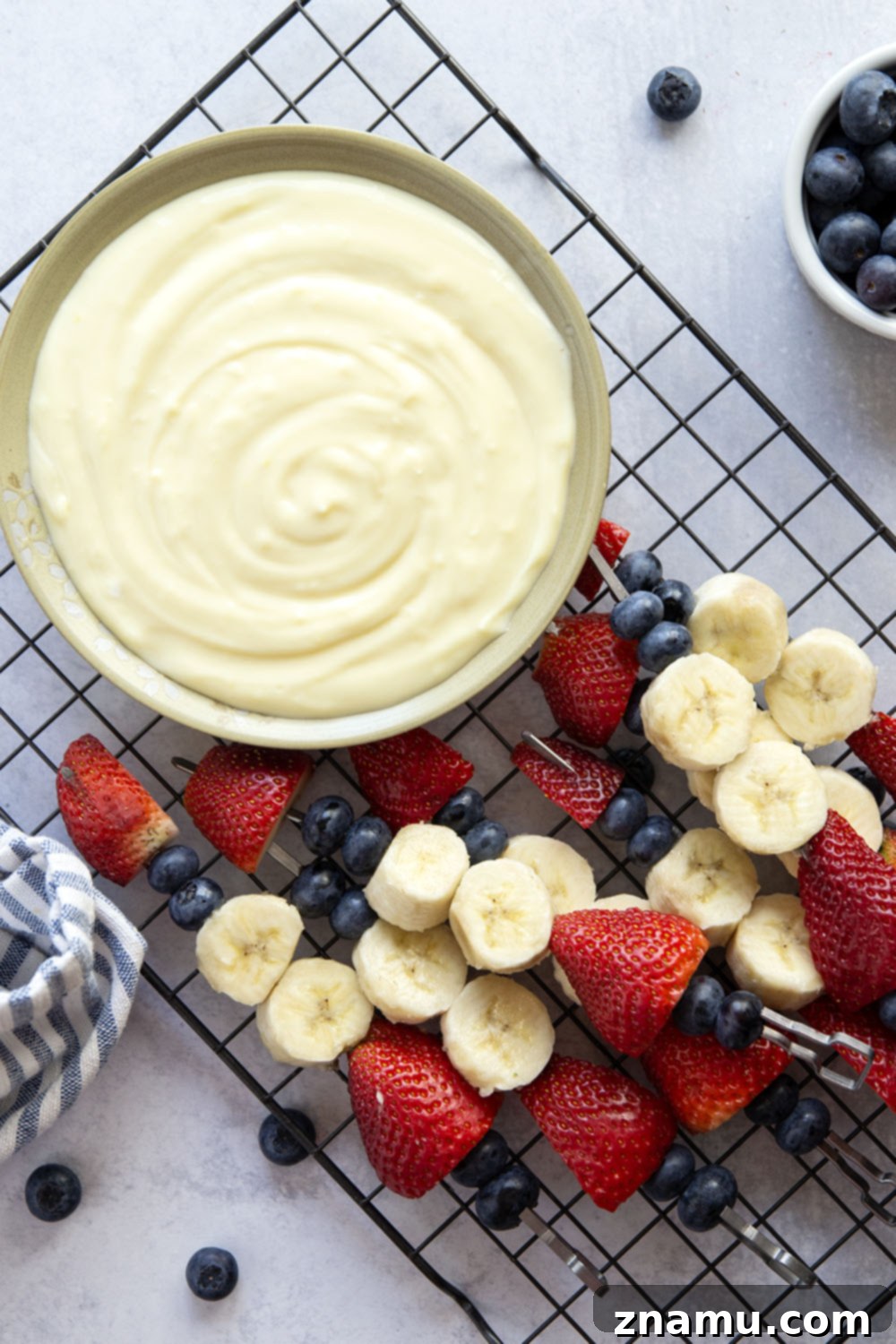 Patriotic Fruit Skewers with Creamy Vanilla Dip 5 Ingredients laid out for making Red White and Blue Fruit Kabobs and Vanilla Pudding Dip.