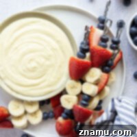 Patriotic Fruit Skewers with Creamy Vanilla Dip 8 Vibrant Red White and Blue Fruit Kabobs with Creamy Vanilla Pudding Dip, perfect for patriotic celebrations.
