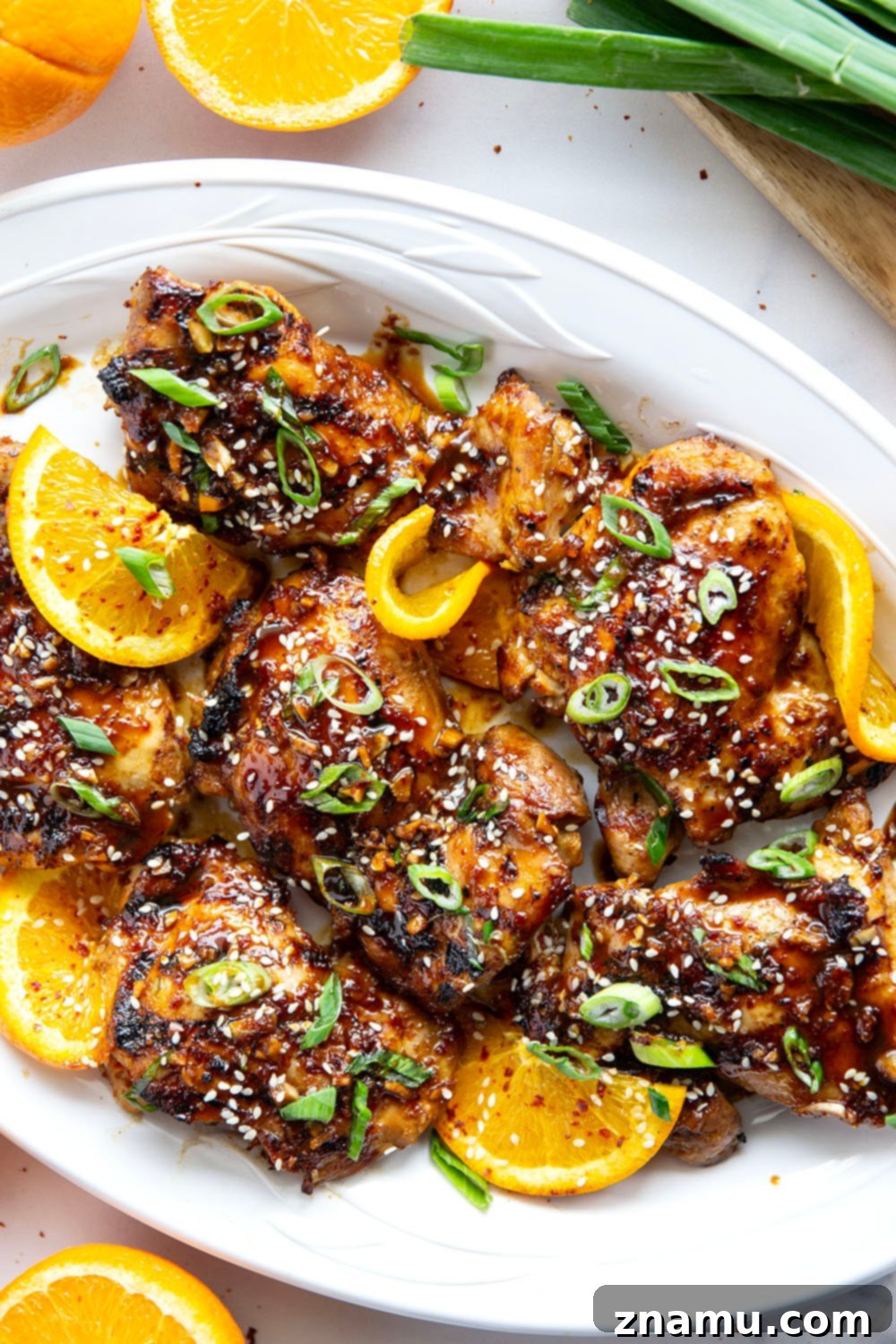 Fiery Orange Glazed Chicken 2 Marinated in a spicy fresh orange sauce and grilled to smoky perfection, this orange marinated chicken will quickly become a cookout favorite.