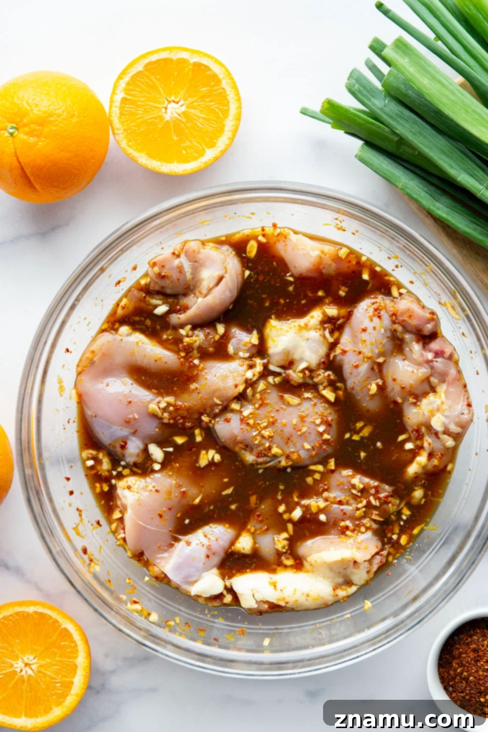 Fiery Orange Glazed Chicken 3 Marinated in a spicy fresh orange sauce and grilled to smoky perfection, this orange marinated chicken will quickly become a cookout favorite.