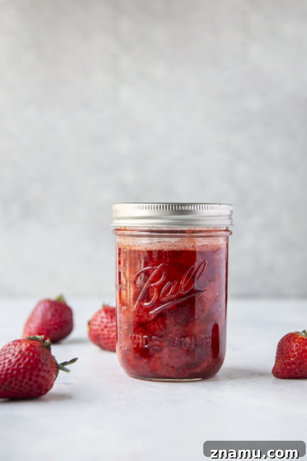 Luscious Homemade Strawberry Sauce 5 A charming jar of homemade strawberry sauce, ready to be enjoyed.