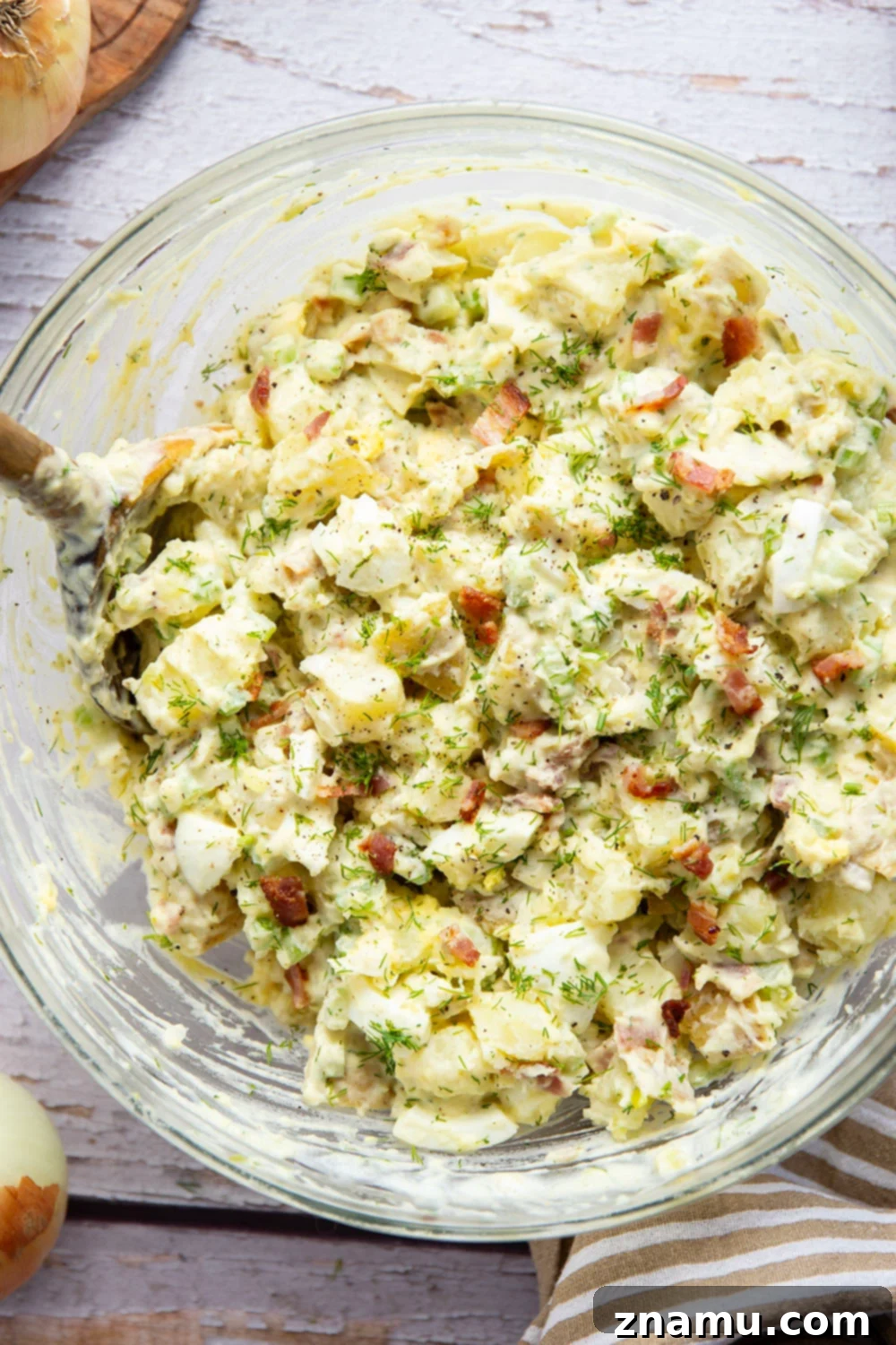 Grandma's Potato Salad 2 A vibrant bowl of Old Fashioned Potato Salad, rich with tender potatoes, crispy bacon, fresh dill, and a creamy, tangy dressing, ready to be served as a delightful side dish.