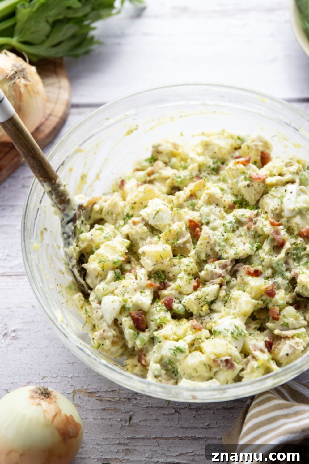 Grandma's Potato Salad 6 A large serving bowl filled with Old Fashioned Potato Salad, ready to be presented at a gathering, highlighting its classic appeal.