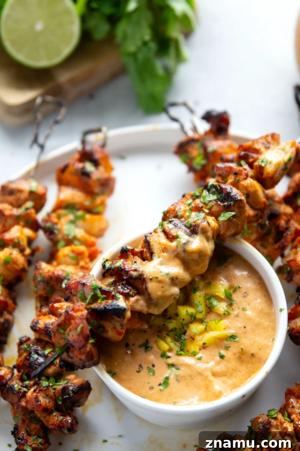 Mango Glazed Thai Chicken Skewers 4 Thai Chicken Skewers served with fresh cilantro and a side of mango dipping sauce.