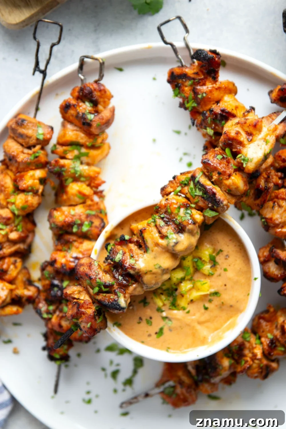 Mango Glazed Thai Chicken Skewers 6 Platter of freshly grilled Thai chicken skewers, ready to be served.