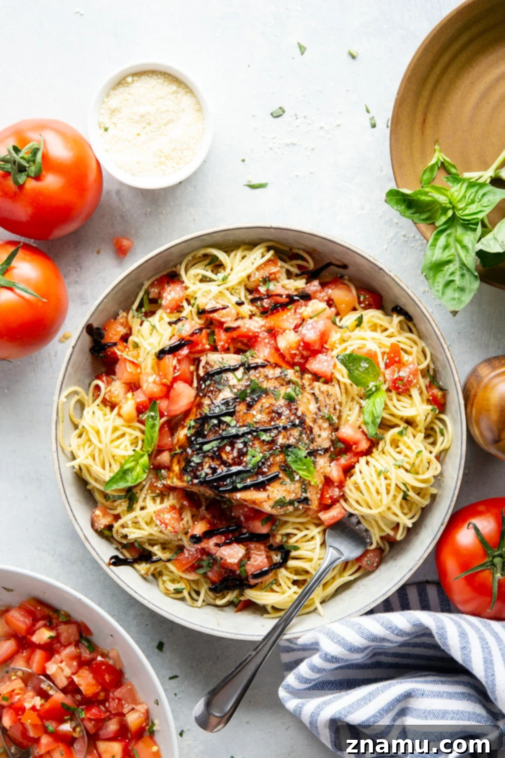 Mediterranean Grilled Salmon Bruschetta Pasta 2 Freshly grilled balsamic salmon fillets and vibrant herb-infused bruschetta tomatoes tossed with angel hair pasta, ready for a delicious summer meal.