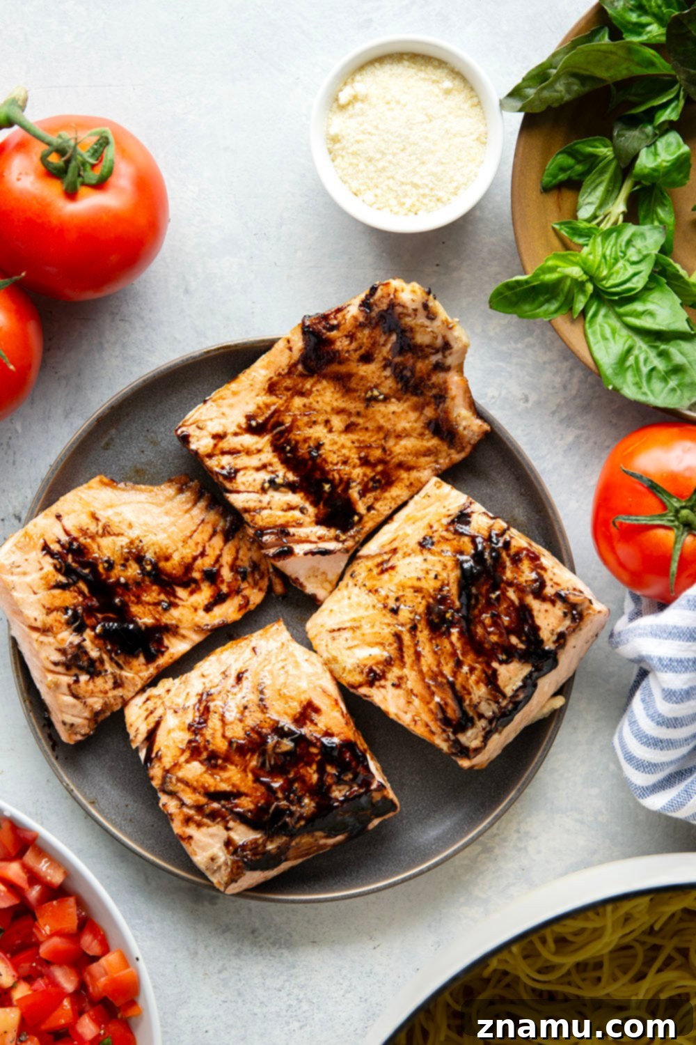 Mediterranean Grilled Salmon Bruschetta Pasta 3 Close-up of buttery balsamic glazed grilled salmon fillets, perfectly charred and flaking, alongside a vibrant fresh tomato and basil bruschetta.