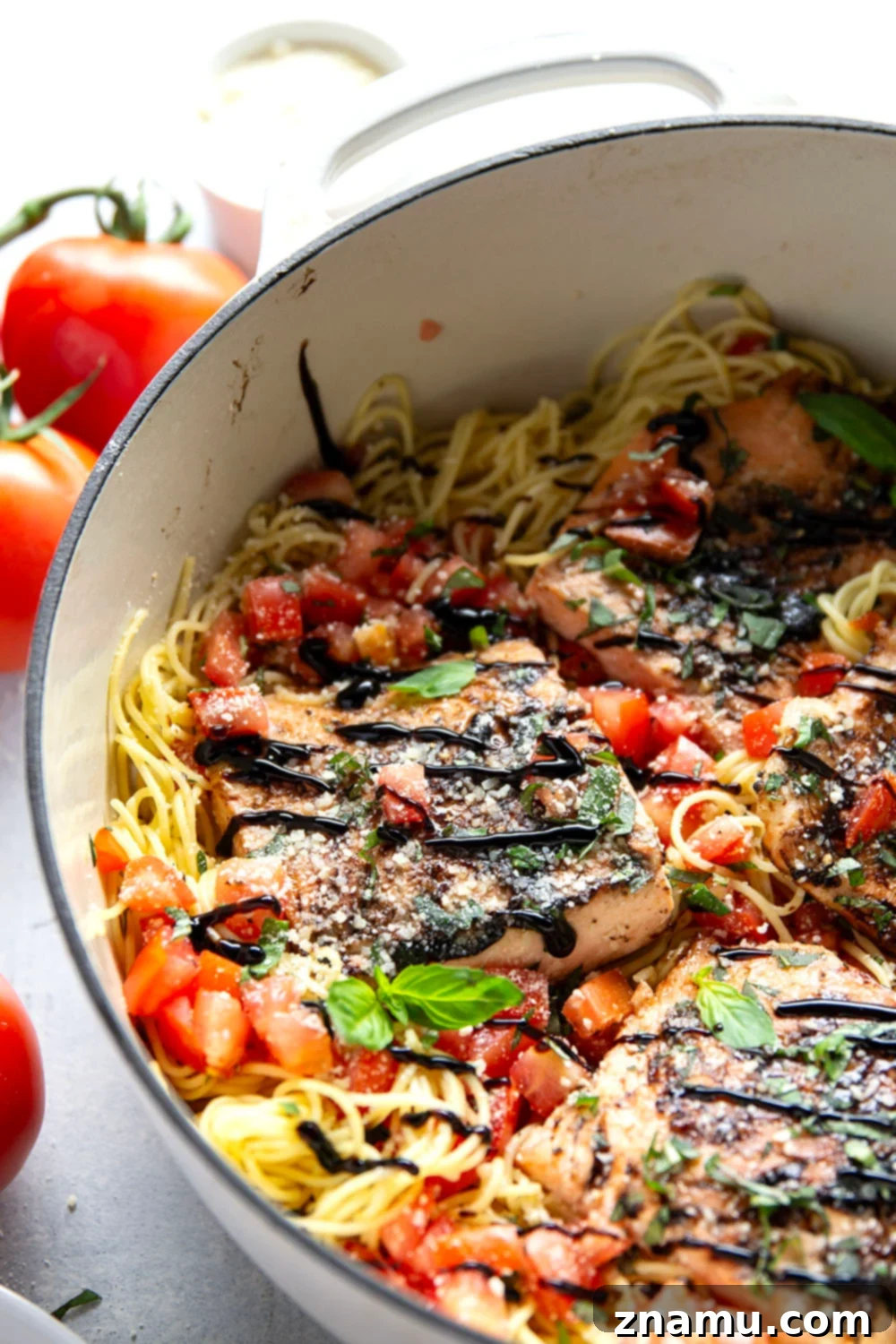 Mediterranean Grilled Salmon Bruschetta Pasta 4 A bowl of angel hair pasta tossed with fresh diced tomatoes, basil, and garlic, ready for the grilled salmon topping.