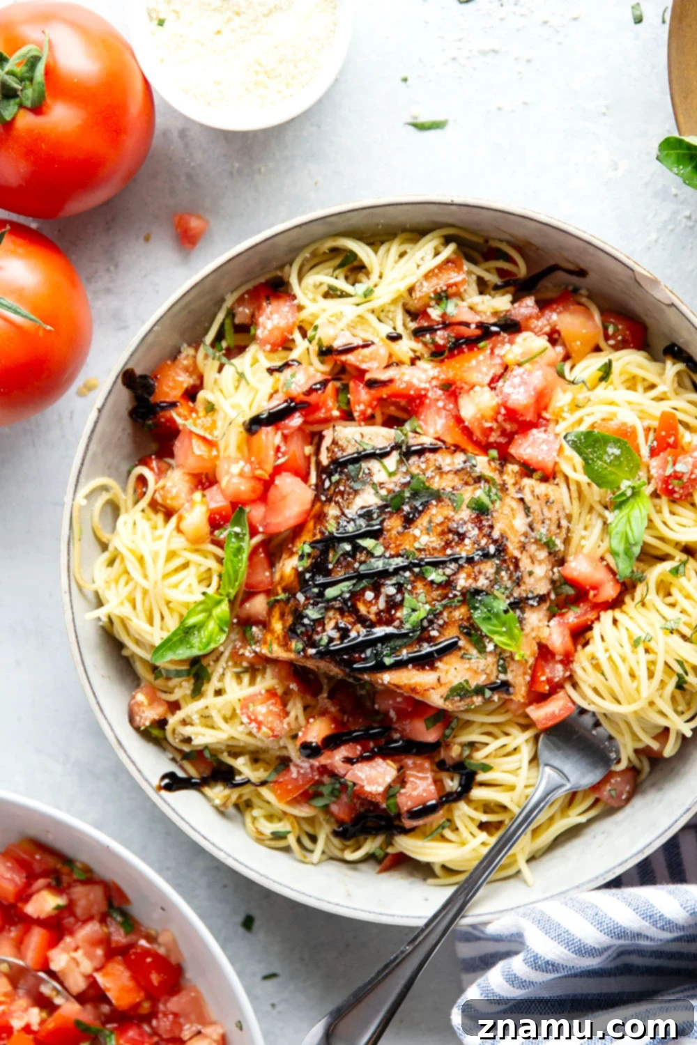 Mediterranean Grilled Salmon Bruschetta Pasta 5 Hand seasoning a raw salmon fillet with olive oil, salt, and pepper, preparing it for grilling.