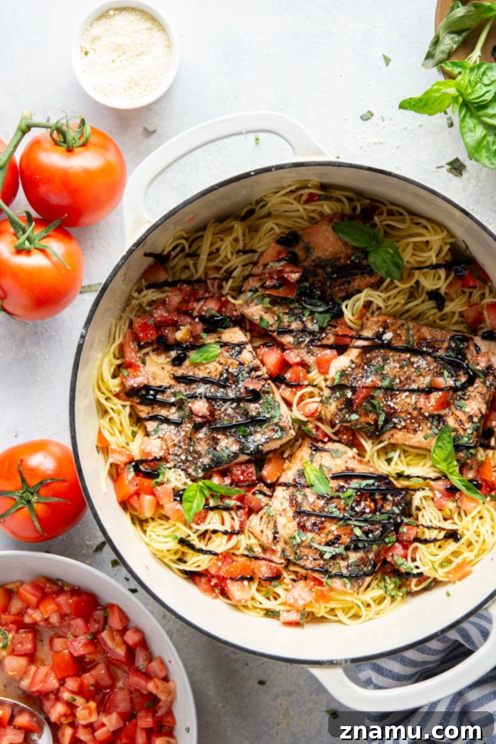 Mediterranean Grilled Salmon Bruschetta Pasta 6 Close-up of a finished bowl of Grilled Salmon Bruschetta Pasta, with flaky salmon, fresh tomatoes, and basil on angel hair.