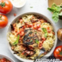 Grilled Salmon Bruschetta Pasta is a fresh and flavorful summer dish with flaky salmon and herby tomatoes.