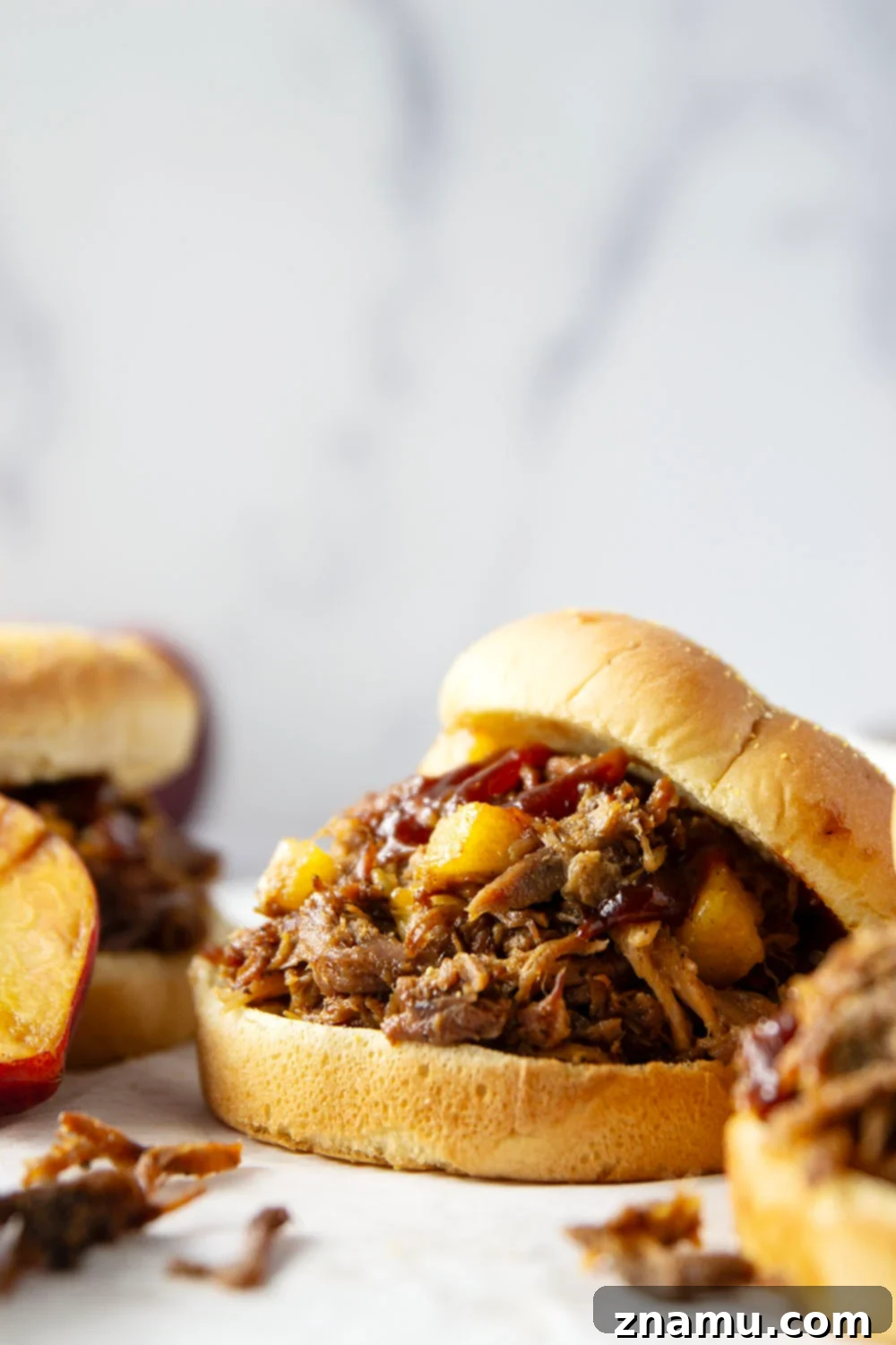 Sweet Heat Peach Pulled Pork 2 Slowly braised in sweet peaches and spicy hot honey, this peach hot honey pulled pork is fall-apart tender and makes one incredible sandwich!