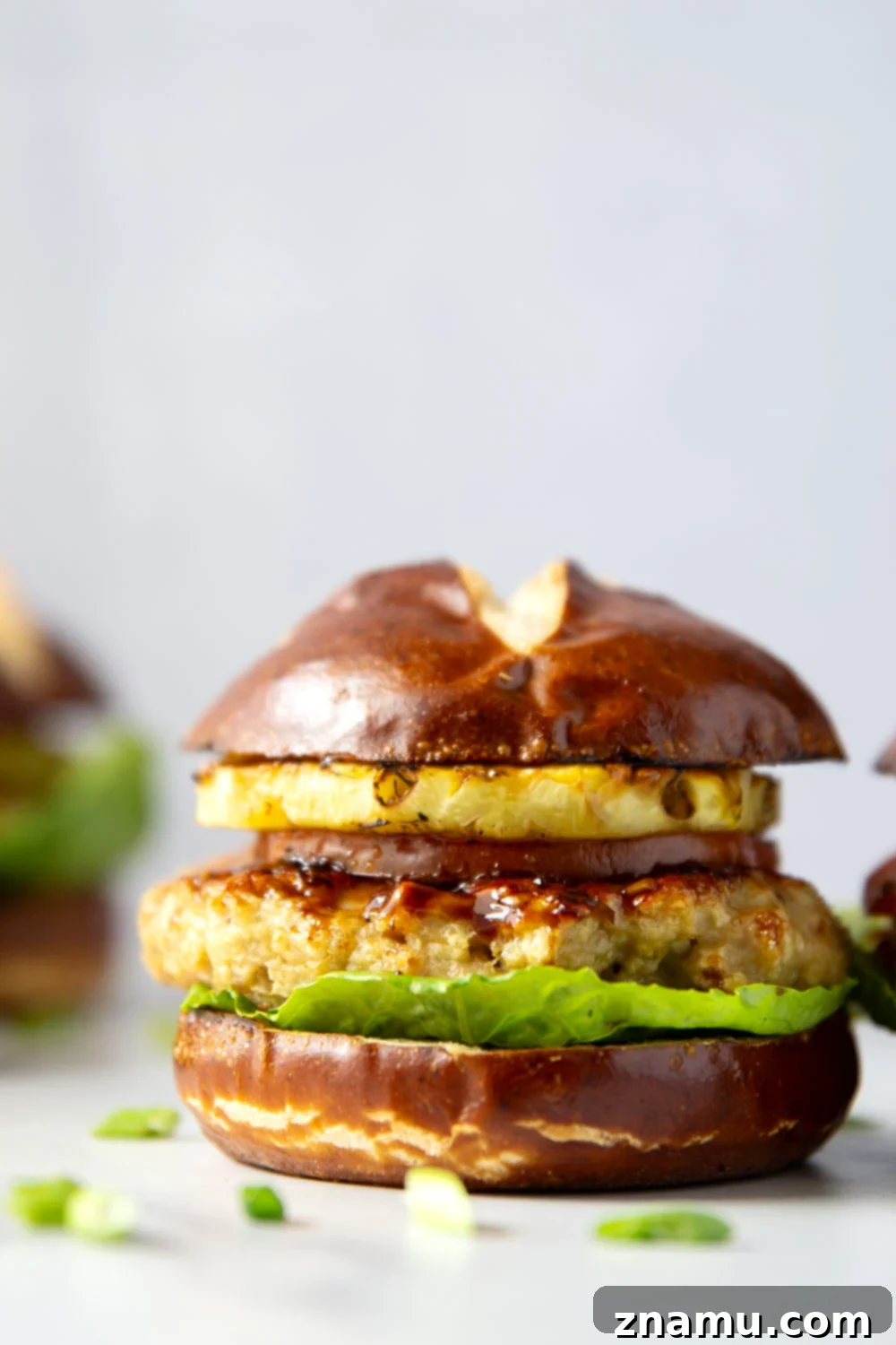 These teriyaki pineapple chicken burgers feature juicy chicken patties brushed with a homemade teriyaki sauce and grilled alongside sweet pineapple rings all piled into an unforgettable burger!