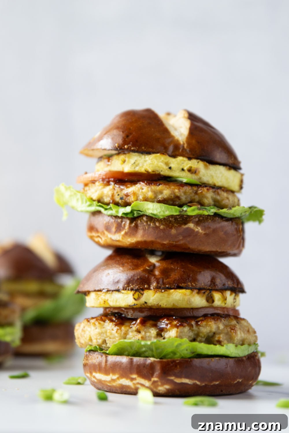 These teriyaki pineapple chicken burgers feature juicy chicken patties brushed with a homemade teriyaki sauce and grilled alongside sweet pineapple rings all piled into an unforgettable burger!