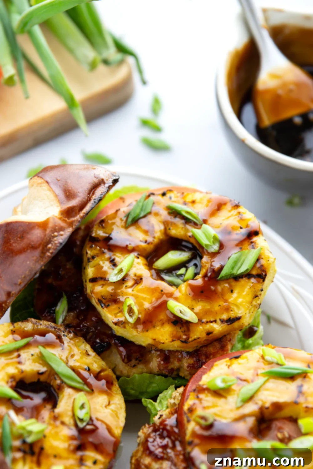 These teriyaki pineapple chicken burgers feature juicy chicken patties brushed with a homemade teriyaki sauce and grilled alongside sweet pineapple rings all piled into an unforgettable burger!