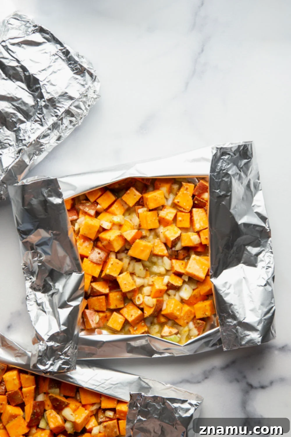 Grilled sweet potatoes in foil with homemade honey mustard sauce, a perfect summer side dish.