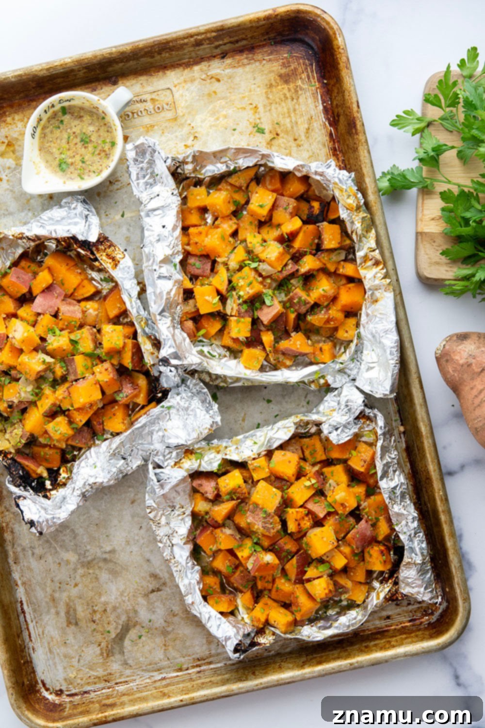 Close-up of tender, smoky grilled sweet potatoes and sweet onion tossed in homemade honey mustard sauce.