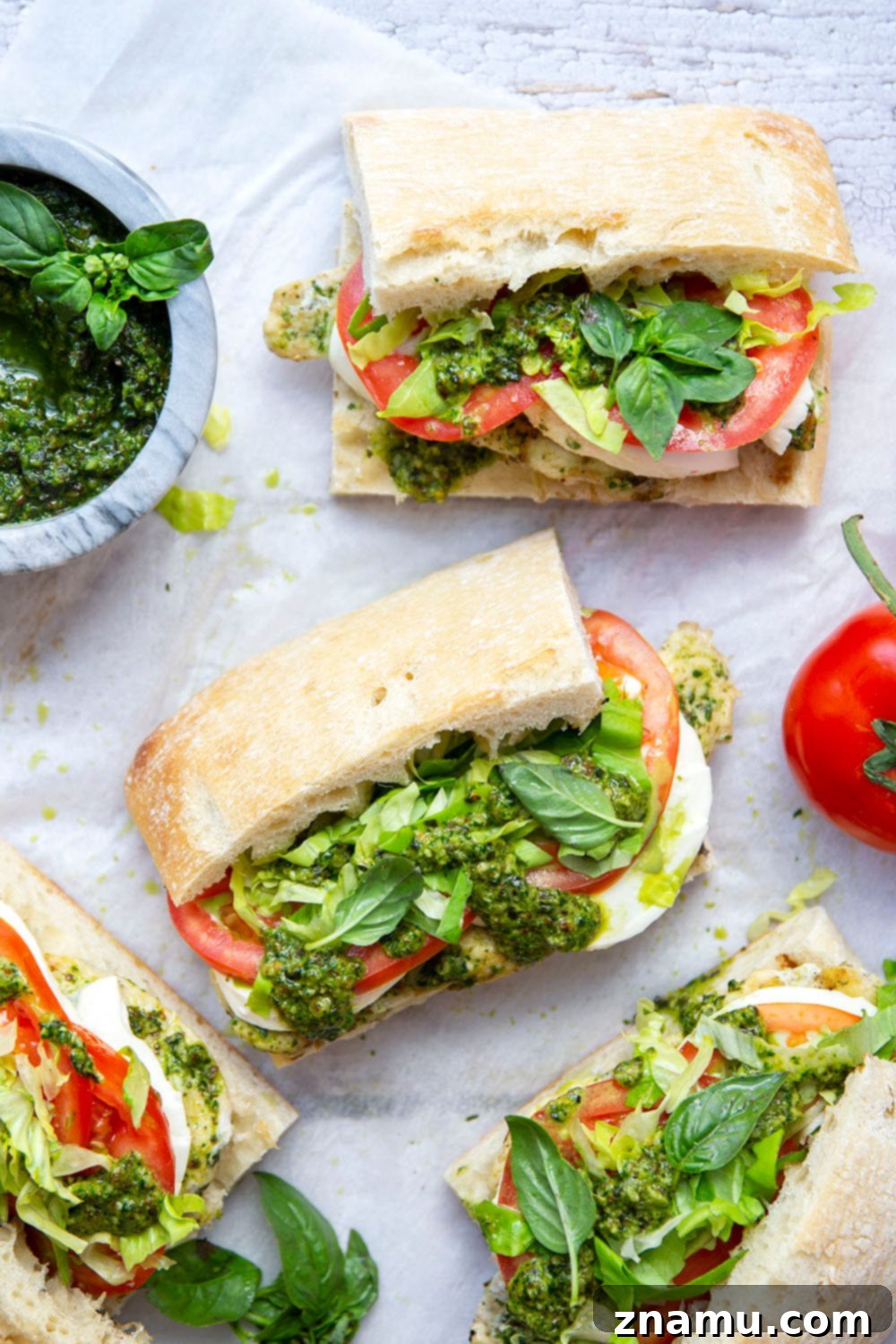 These sandwiches feature smoky pesto grilled chicken sandwiched between soft ciabatta bread with lots of fresh tomato and mozzarella.