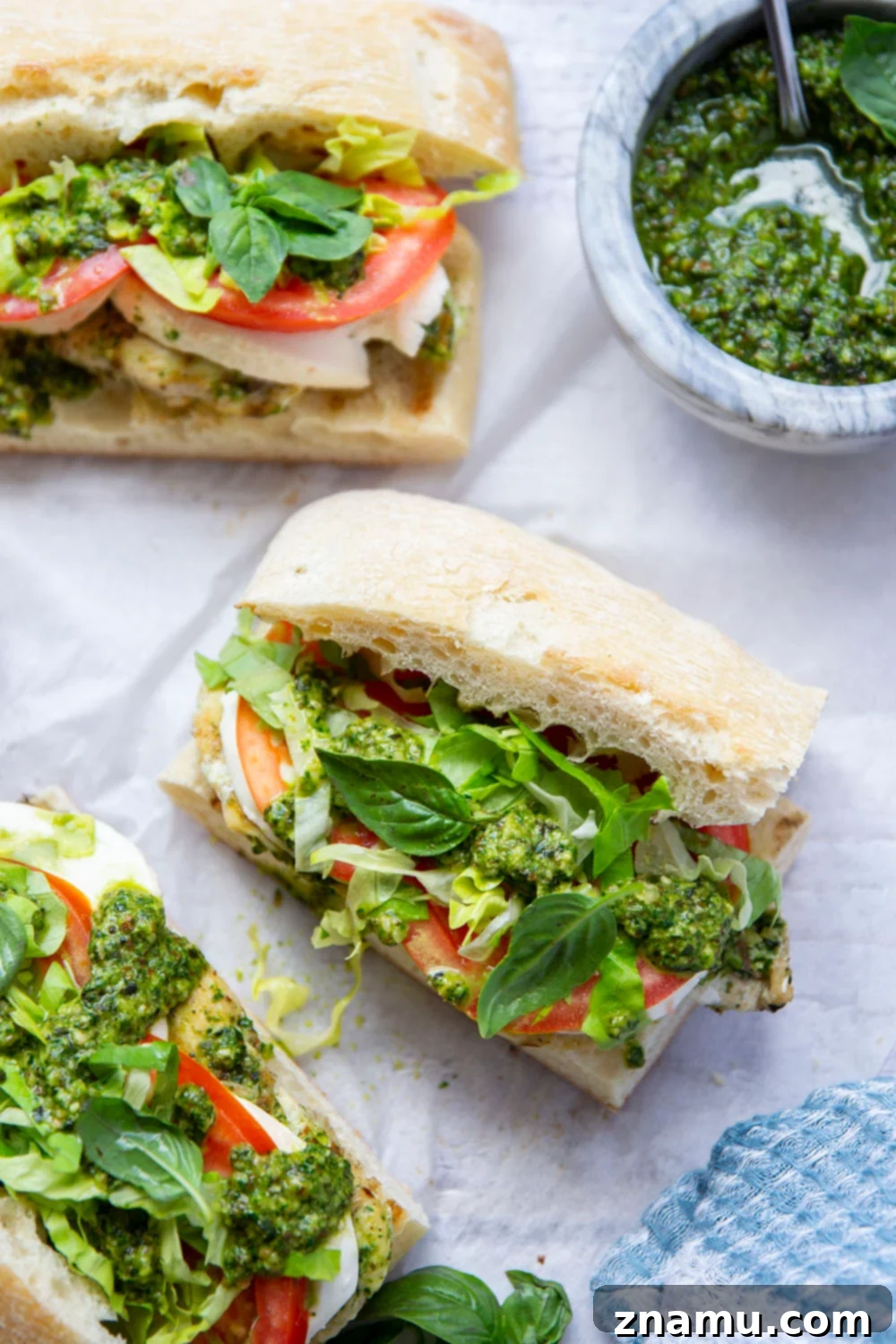 These sandwiches feature smoky pesto grilled chicken sandwiched between soft ciabatta bread with lots of fresh tomato and mozzarella.