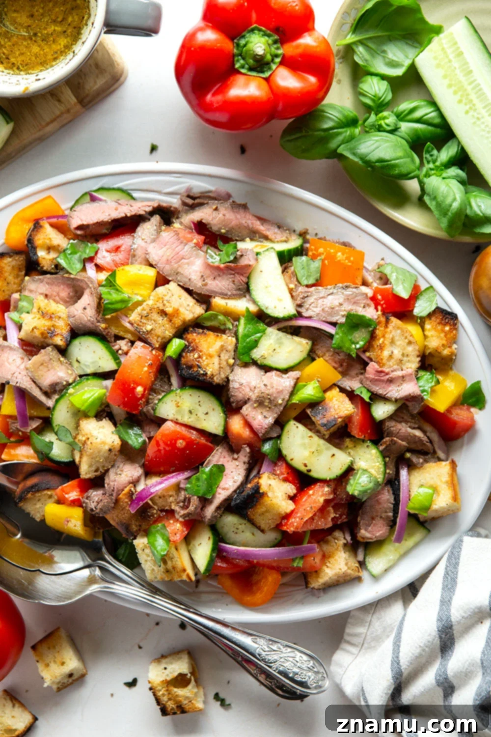 Savory Grilled Steak Panzanella 2 Juicy grilled steak, charred bread cubes, juicy tomatoes, and lots of fresh basil make for the perfect summery meal in this grilled steak panzanella salad.