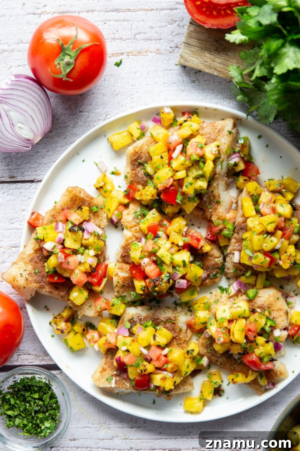 Tropical Jerk Cod with Sweet Pineapple Salsa 2 Jerk Cod fillets with grilled pineapple salsa, showcasing a vibrant, healthy, and flavorful seafood dish.