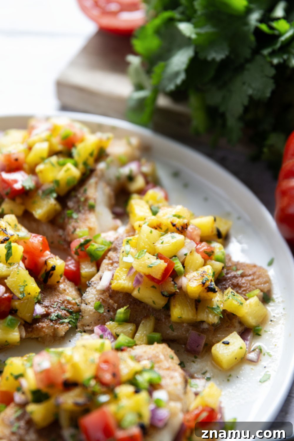 Tropical Jerk Cod with Sweet Pineapple Salsa 6 Plated Jerk Cod with pineapple salsa and a side of rice, ready to be enjoyed.