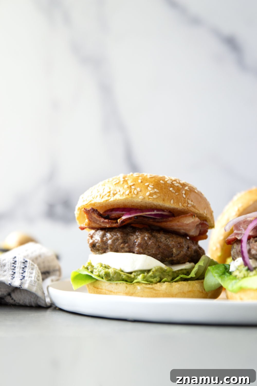The Ultimate Avocado Bacon Burger 2 These avocado bacon burgers are unbelievably juicy inside and loaded up with crispy bacon, soft mozzarella, and lots of creamy smashed avocado.