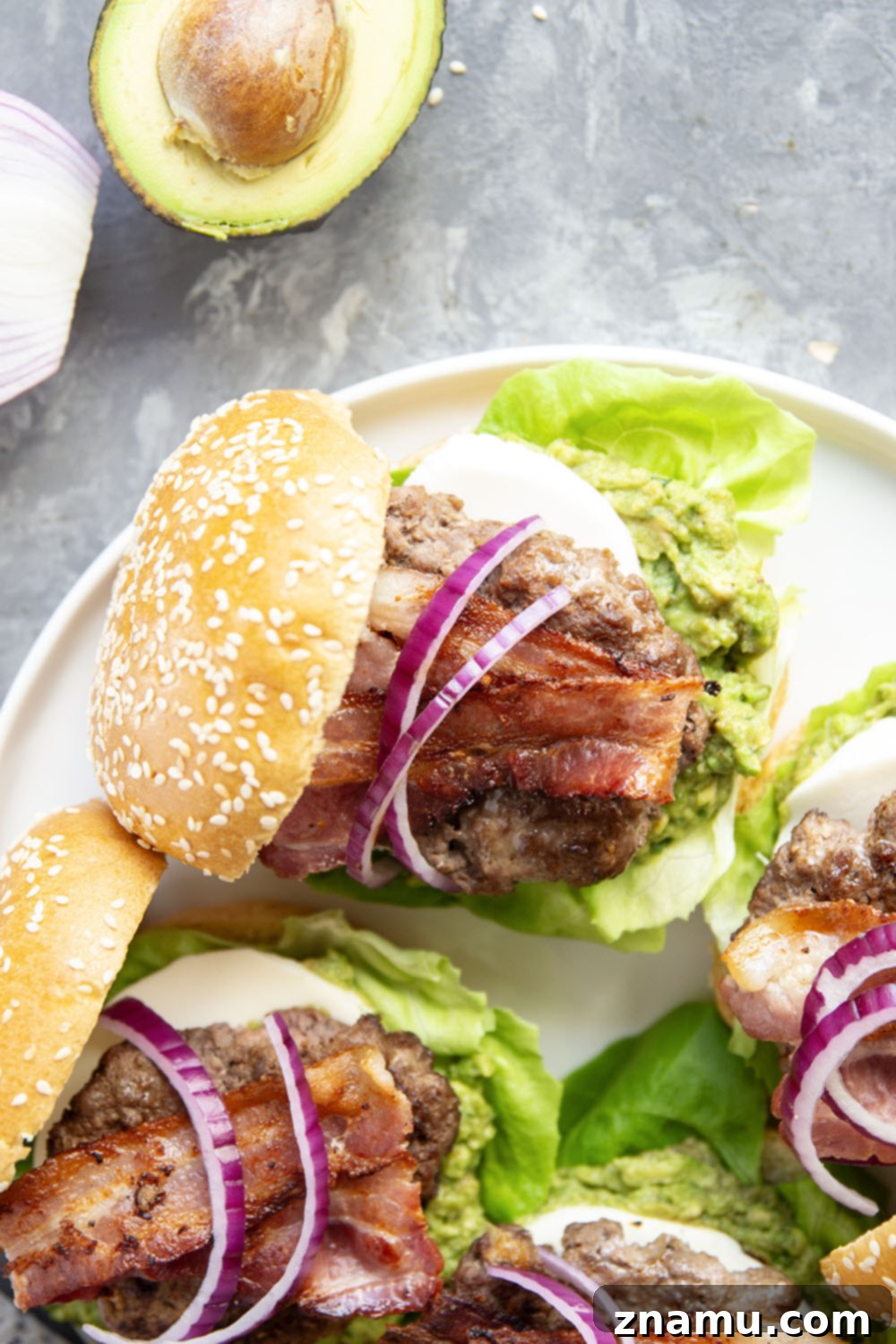 The Ultimate Avocado Bacon Burger 3 These avocado bacon burgers are unbelievably juicy inside and loaded up with crispy bacon, soft mozzarella, and lots of creamy smashed avocado.