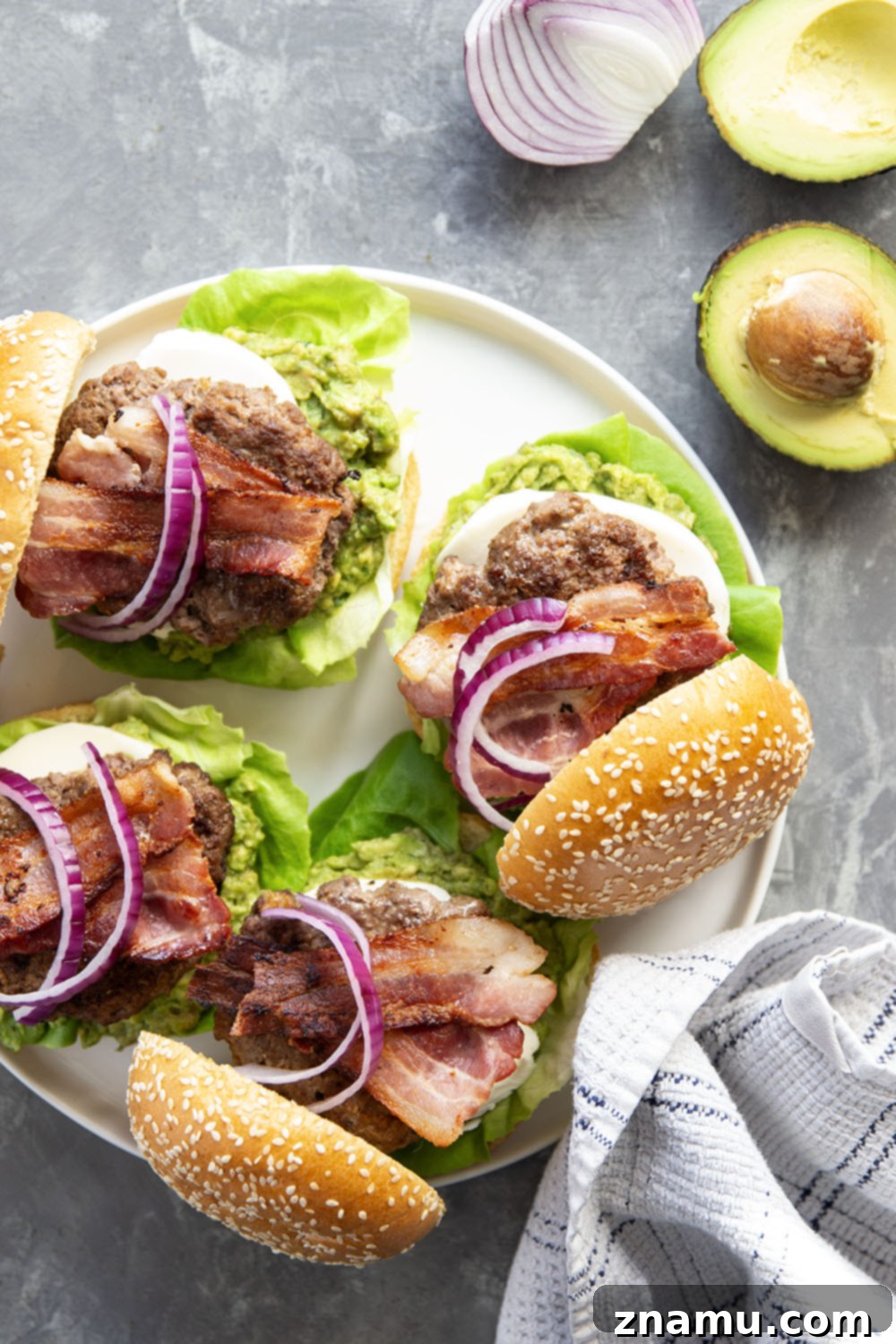 The Ultimate Avocado Bacon Burger 4 These avocado bacon burgers are unbelievably juicy inside and loaded up with crispy bacon, soft mozzarella, and lots of creamy smashed avocado.