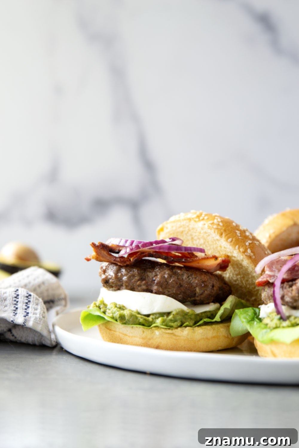 The Ultimate Avocado Bacon Burger 5 These avocado bacon burgers are unbelievably juicy inside and loaded up with crispy bacon, soft mozzarella, and lots of creamy smashed avocado.