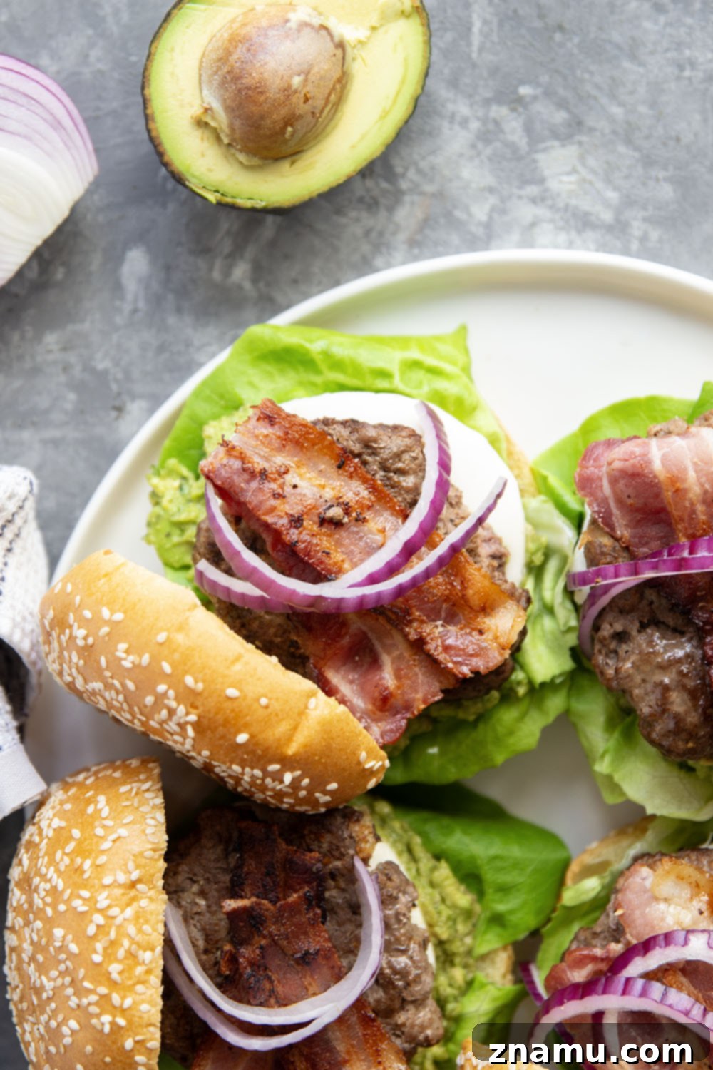 The Ultimate Avocado Bacon Burger 6 These avocado bacon burgers are unbelievably juicy inside and loaded up with crispy bacon, soft mozzarella, and lots of creamy smashed avocado.
