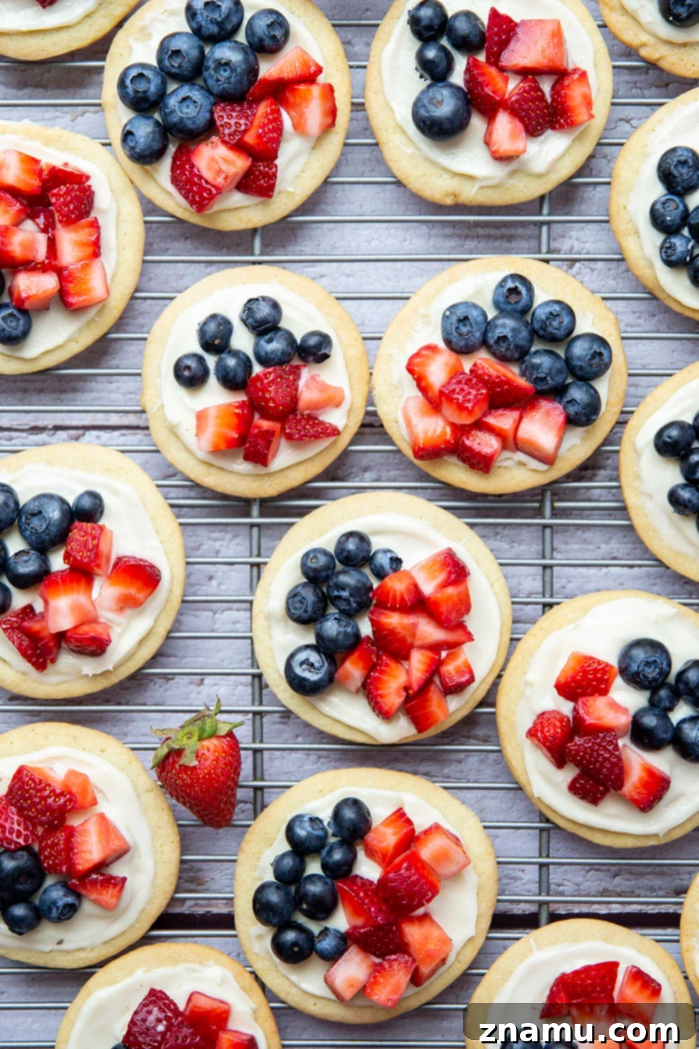 Star-Spangled Fruit Pizza Bites 3 These fruit pizzas feature soft sugar cookies topped with a cream cheese frosting and fresh blueberries and strawberries for a fun 4th of July dessert!