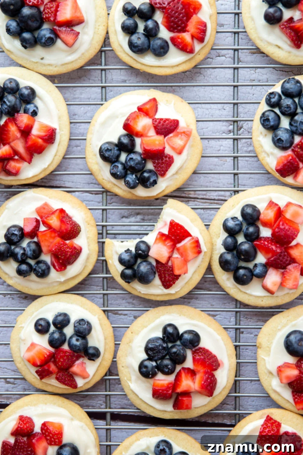 Star-Spangled Fruit Pizza Bites 6 These fruit pizzas feature soft sugar cookies topped with a cream cheese frosting and fresh blueberries and strawberries for a fun 4th of July dessert!