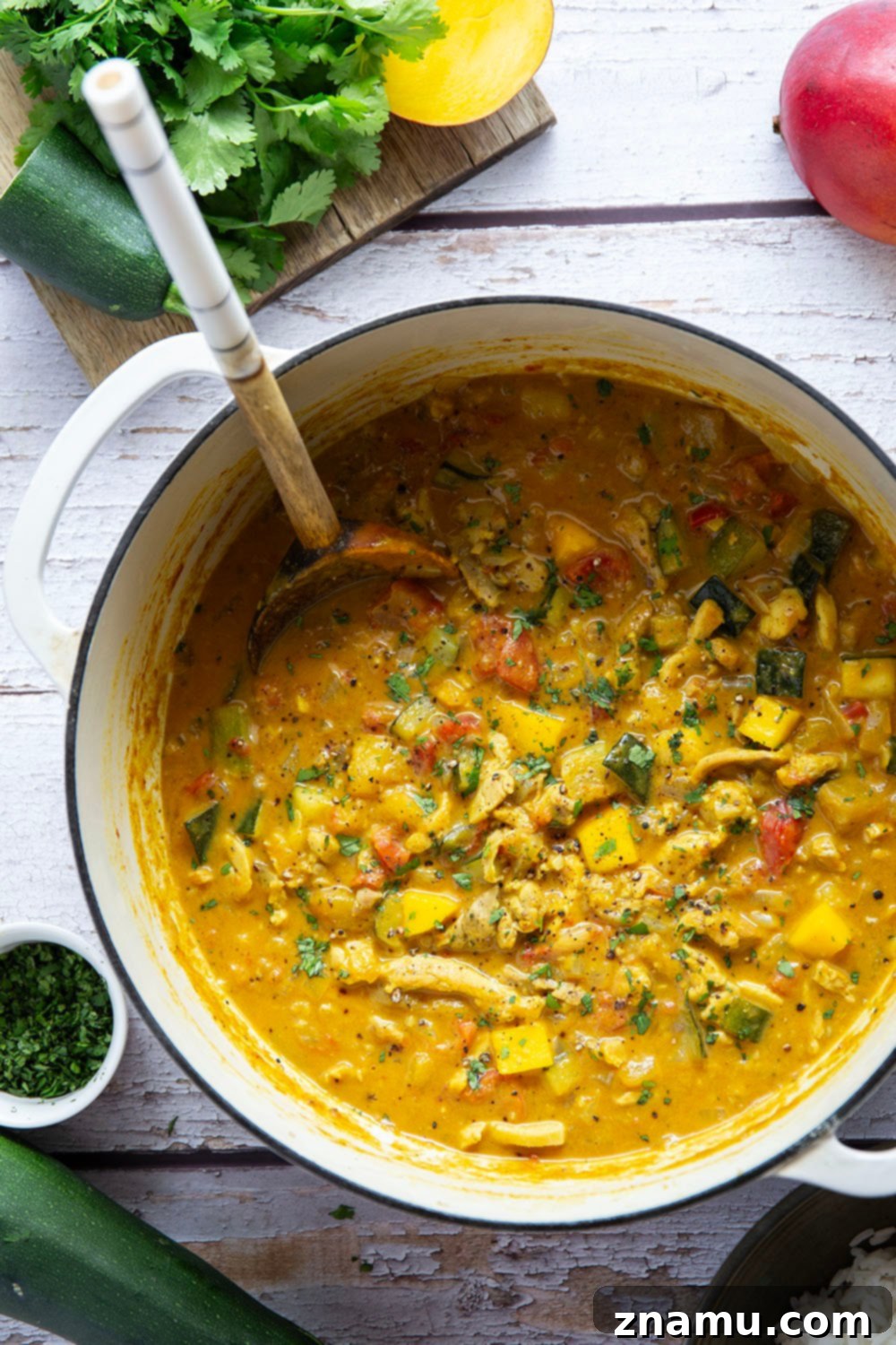 Tropical Zucchini Mango Chicken Curry 2 This mango chicken curry features tender chicken and lots of zucchini simmered in a flavorful fresh mango coconut curry sauce.