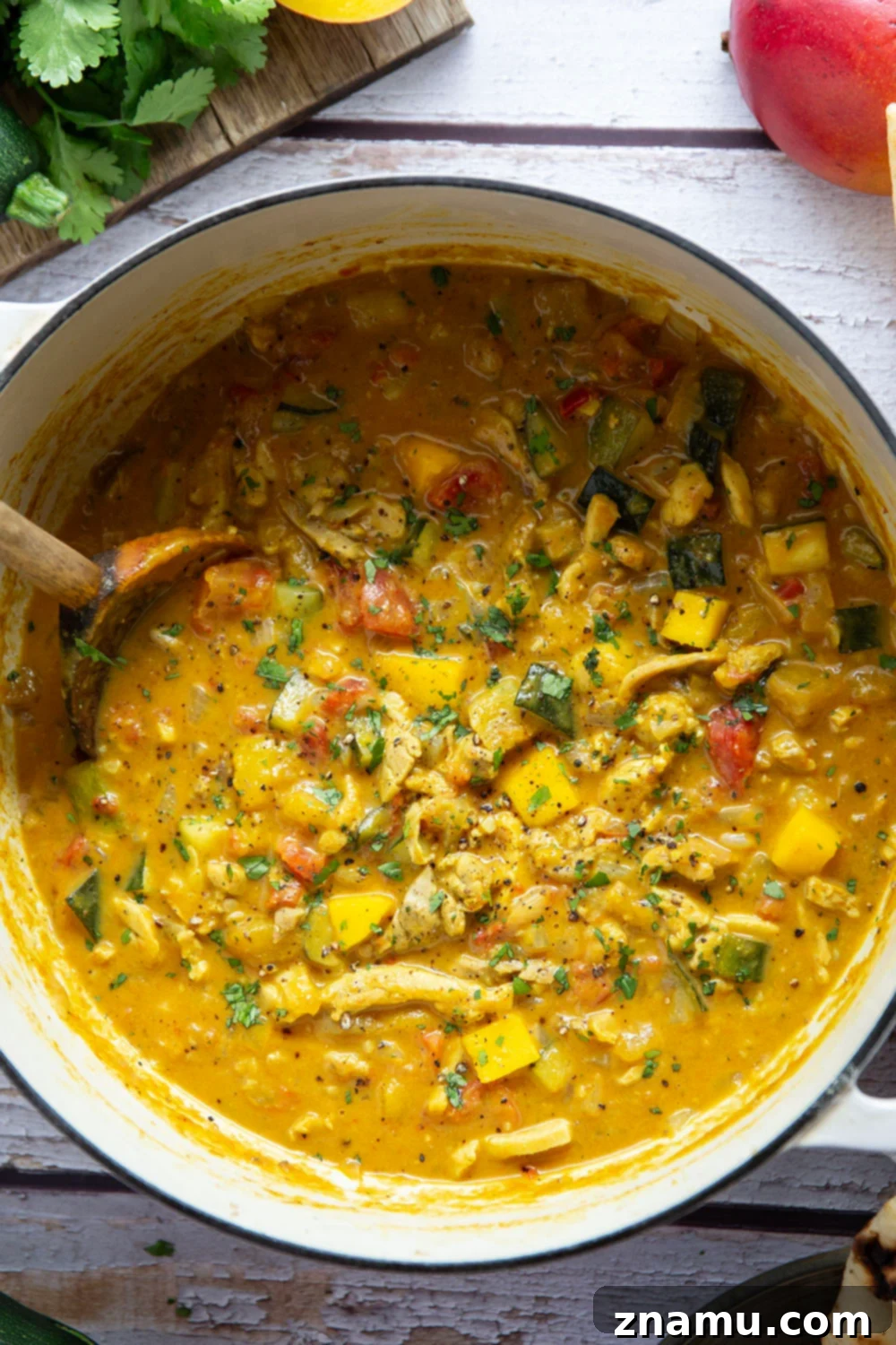 Tropical Zucchini Mango Chicken Curry 4 This mango chicken curry features tender chicken and lots of zucchini simmered in a flavorful fresh mango coconut curry sauce.
