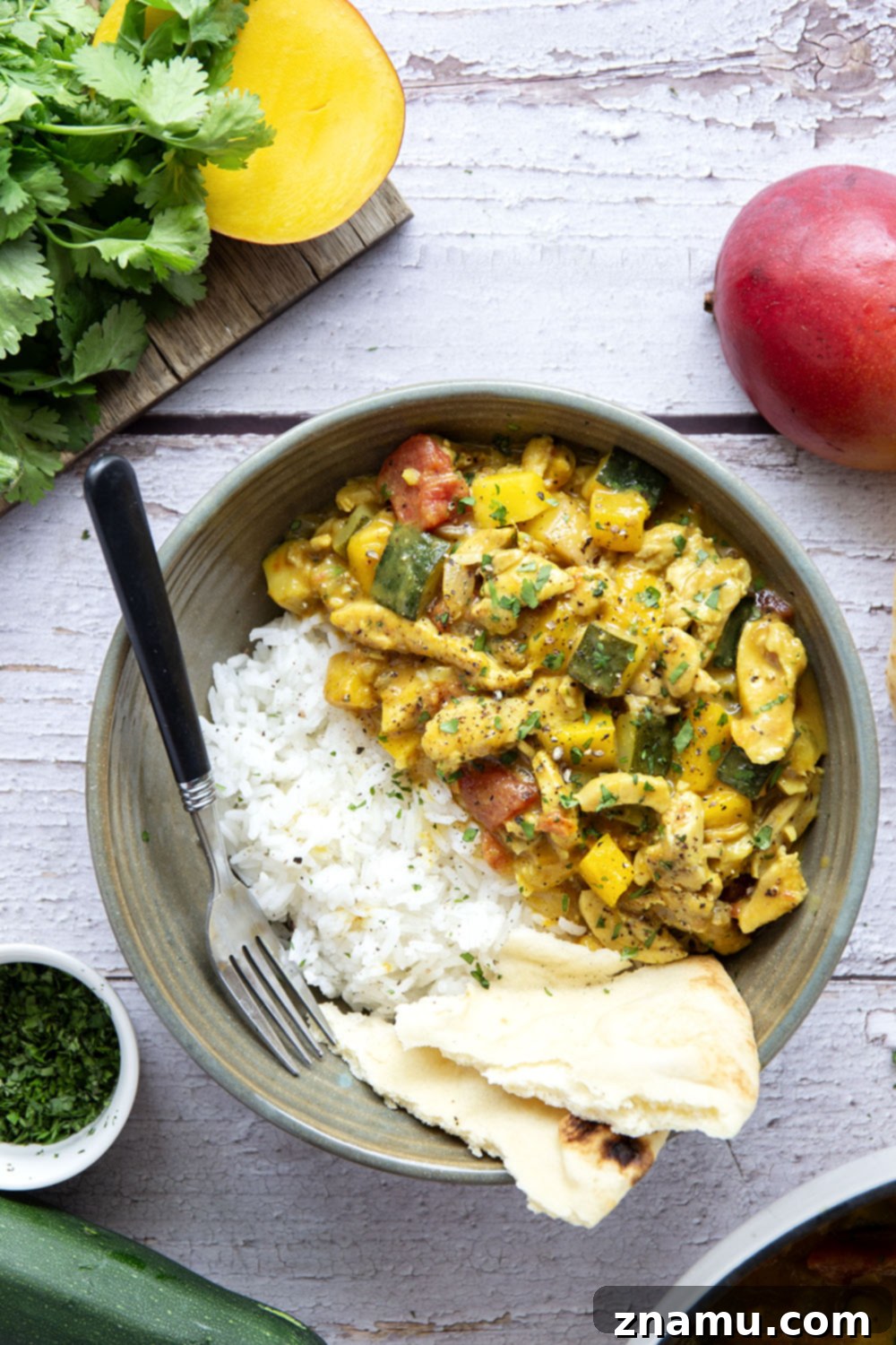 Tropical Zucchini Mango Chicken Curry 5 This mango chicken curry features tender chicken and lots of zucchini simmered in a flavorful fresh mango coconut curry sauce.