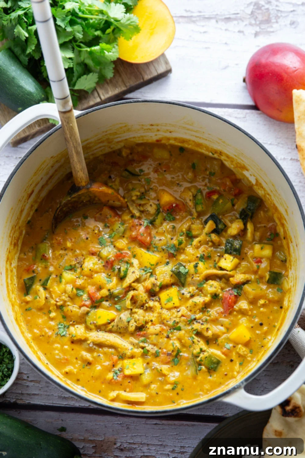 Tropical Zucchini Mango Chicken Curry 6 This mango chicken curry features tender chicken and lots of zucchini simmered in a flavorful fresh mango coconut curry sauce.