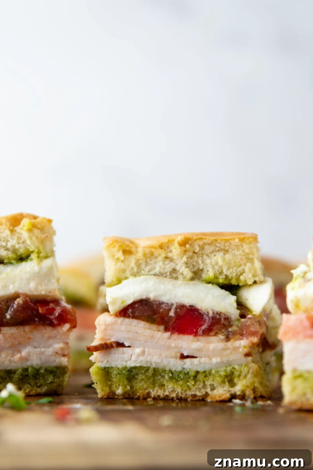 Fresh Pesto Turkey Caprese Sliders 2 Layers of delicious Pesto Turkey Caprese Sliders with basil pesto, sliced turkey, creamy burrata, and fresh tomato on soft slider buns.