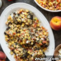 Grilled Tahini Chicken with Peach Feta Salsa presented on a small plate